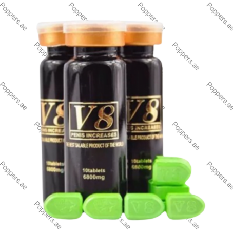 V8 Pills for Sex Delay bottles and green tablets on white background